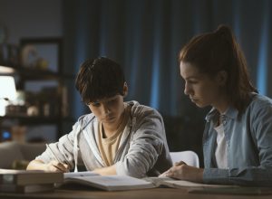 Tutor helping a student with his homework